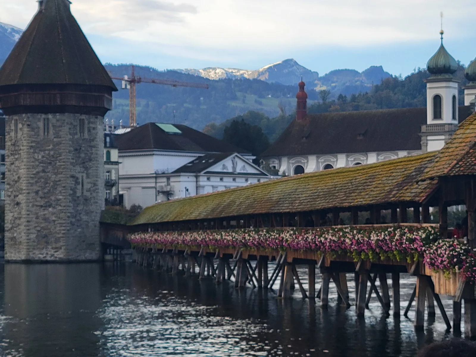 Blue sky above alpine rooftops and a bell tower