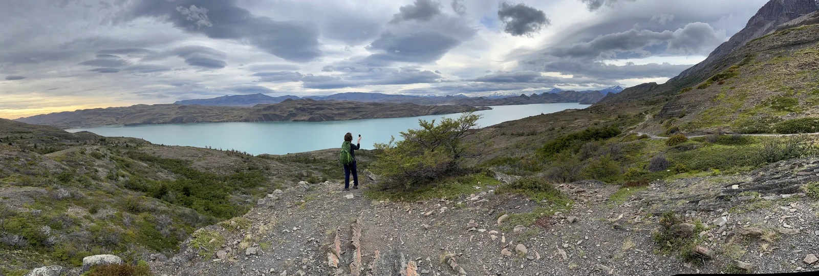 Stream rushing past a large boulder in autumn woods