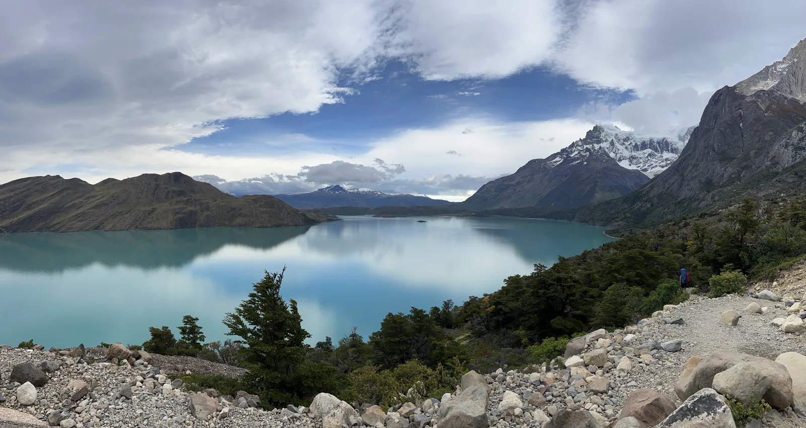 Snow-dusted mountains over a bright blue lake