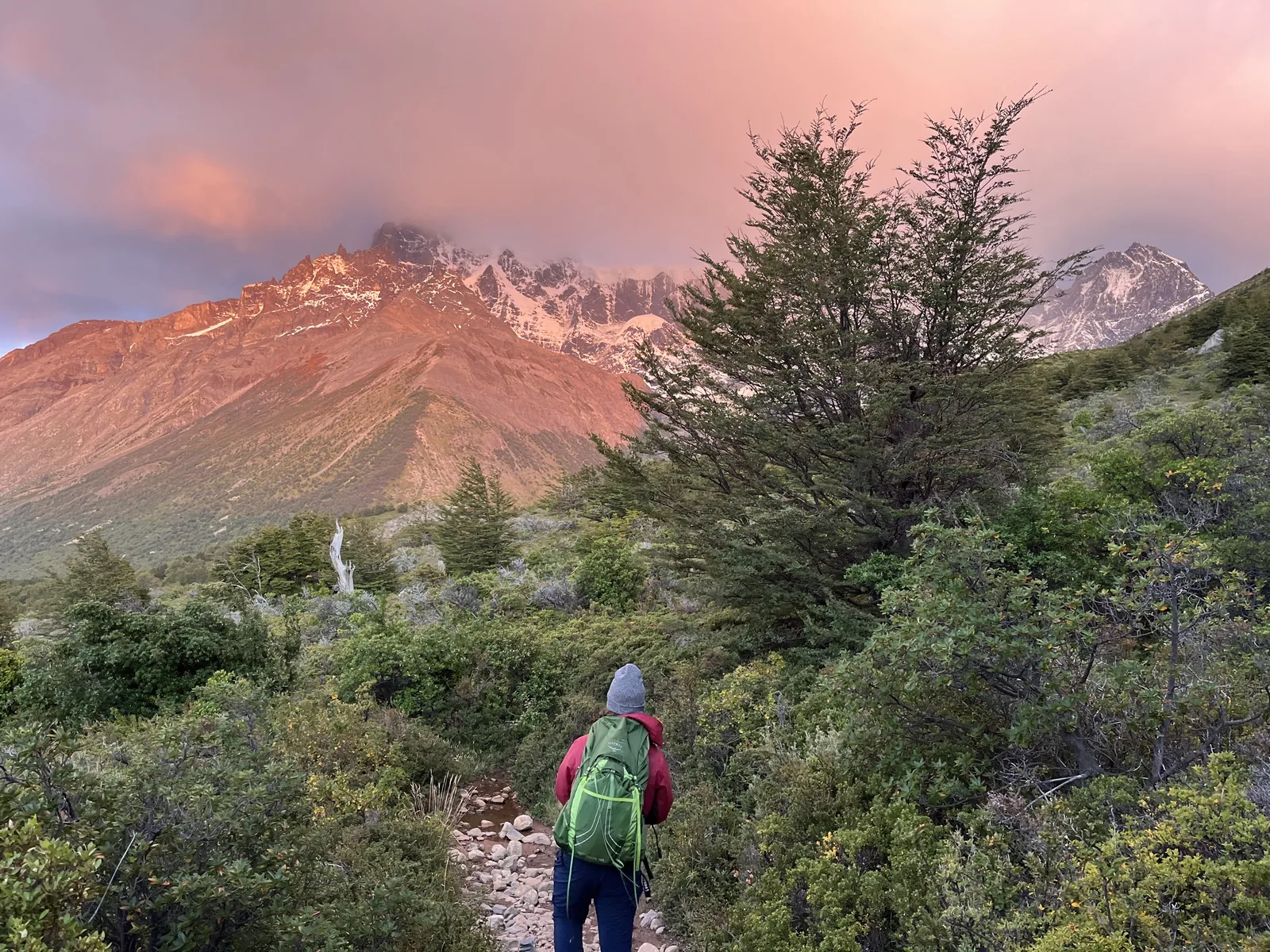 Hiker overlooking a long mountain lake