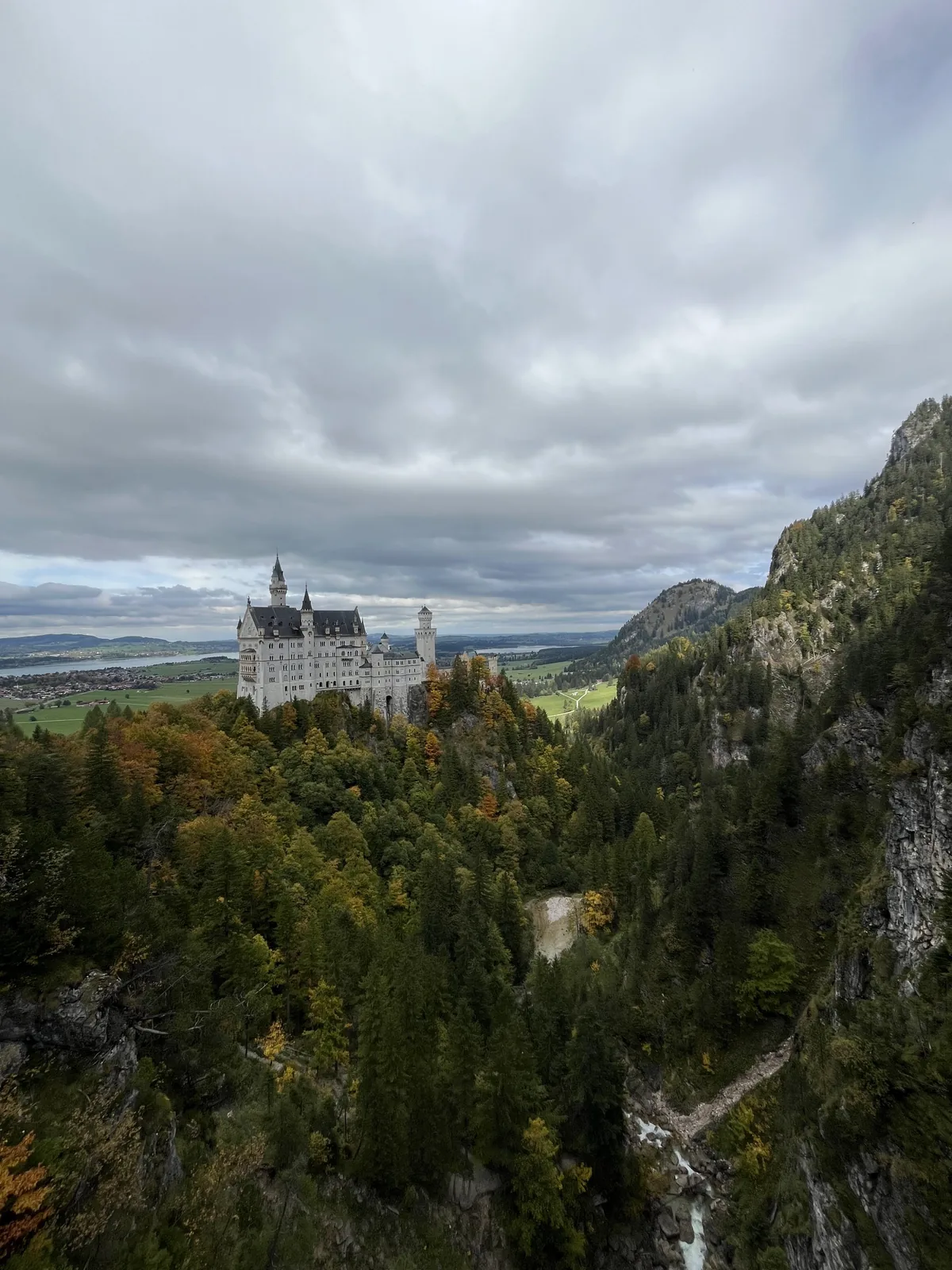 Woman standing by a waterfall in a rocky gorge