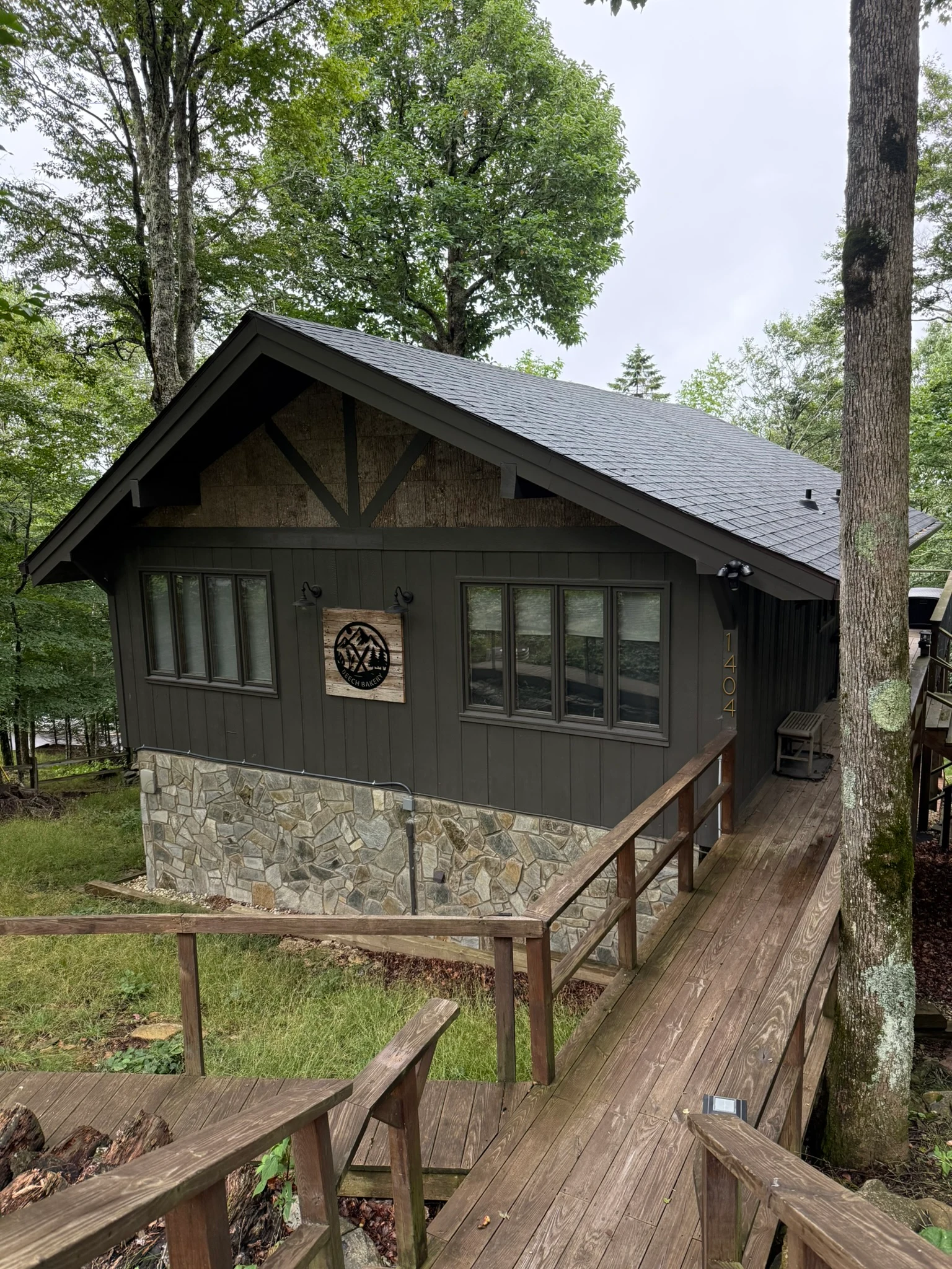 The Beech Bakery cabin exterior surrounded by green summer trees.