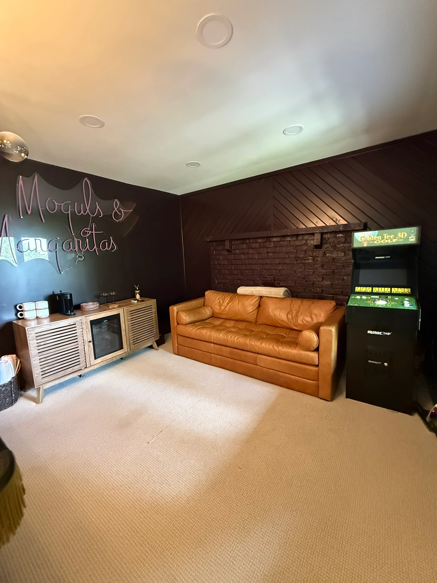 The cabin game room with a pool table and lounge seating.