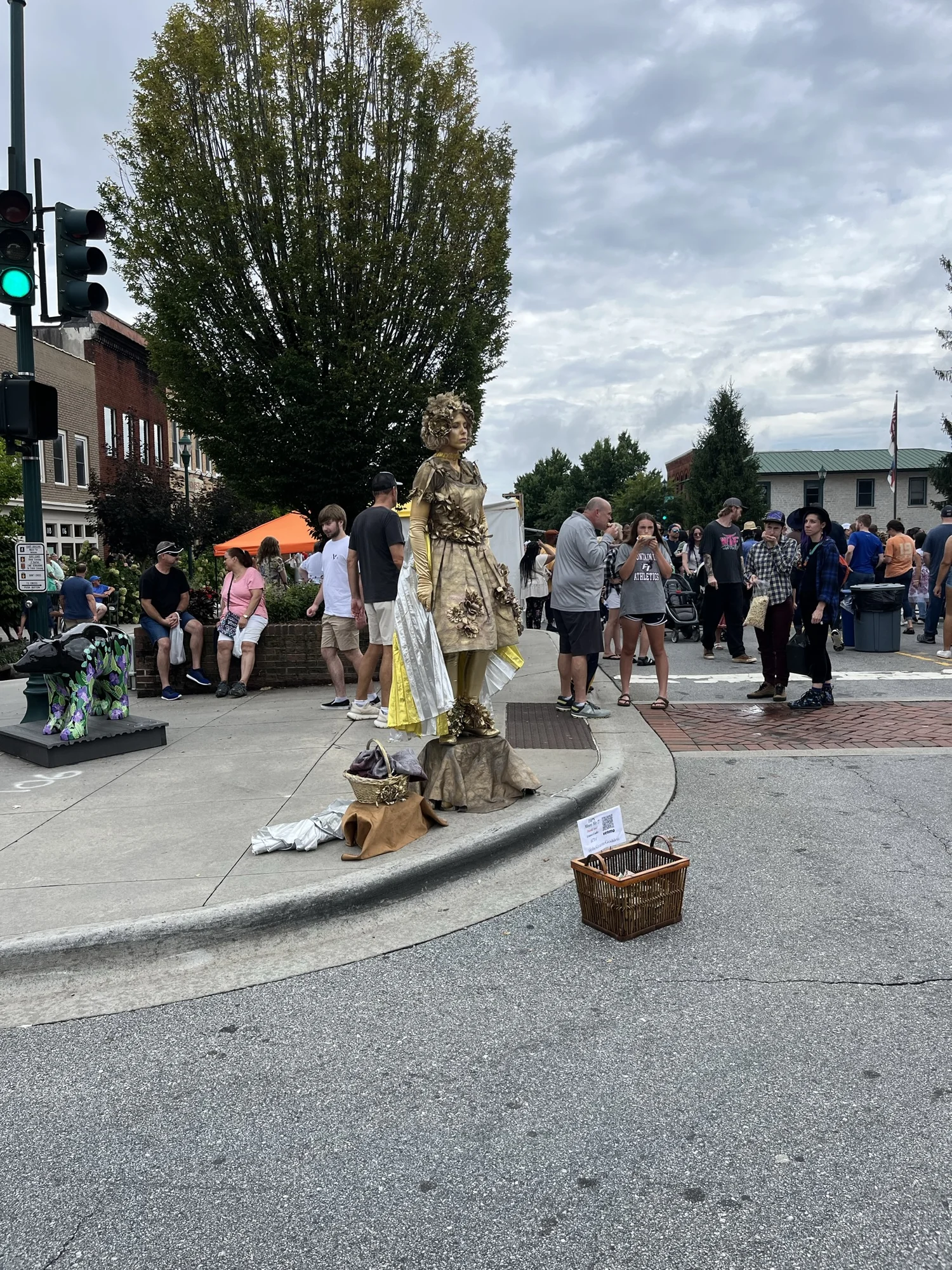 A street performer and spectators at the downtown festival.