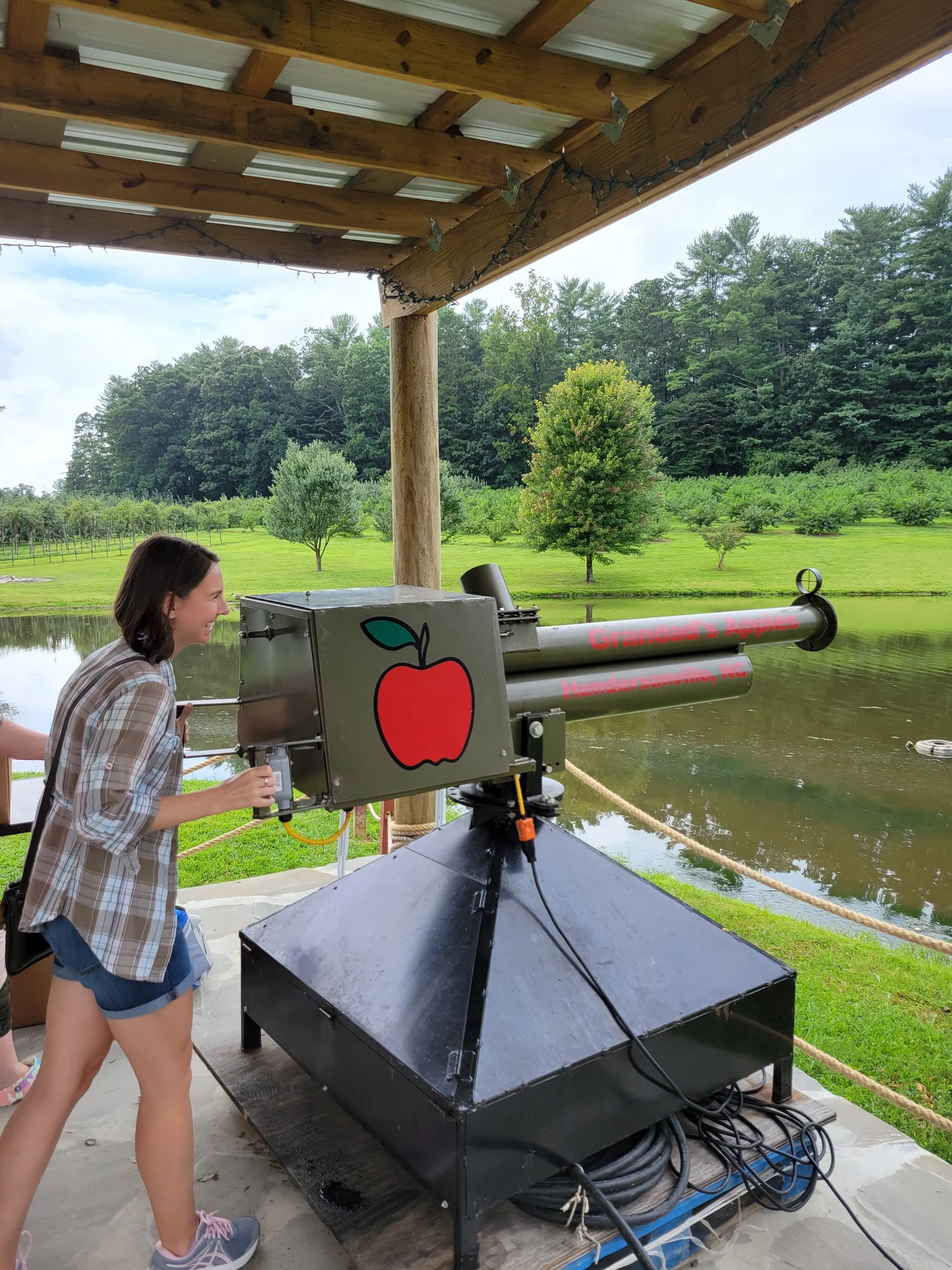 Sydney operating the green apple cannon beside the pond at Grandad’s.