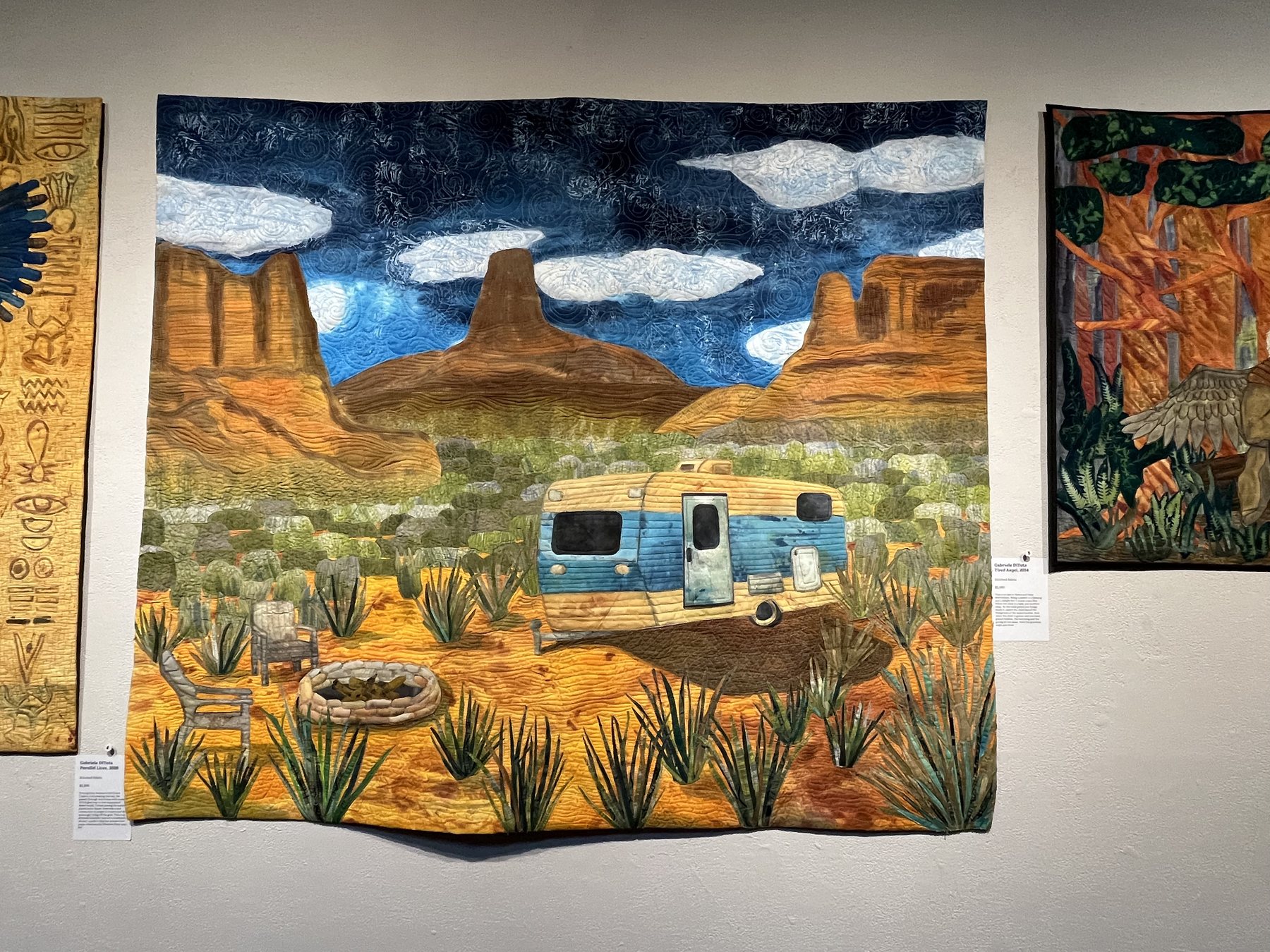 A large desert-toned textile artwork hanging on a gallery wall at Artspace in Raleigh.