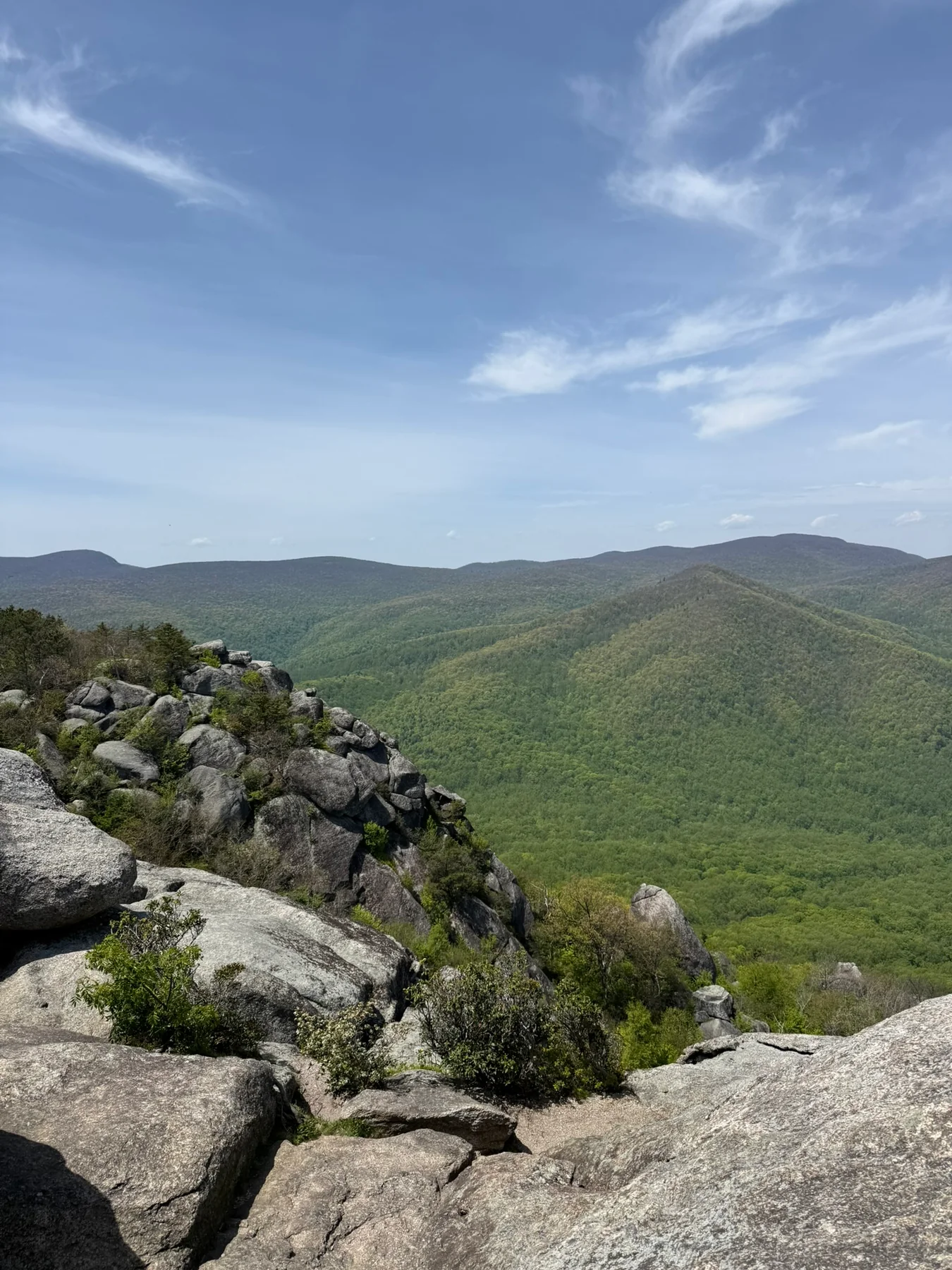 A rocky Old Rag ridge with green Shenandoah mountains stretching into the distance.
